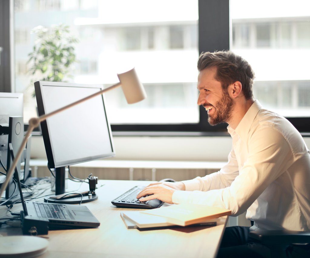 person at computer reading a newsletter in their email