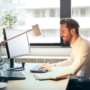 person at computer reading a newsletter in their email