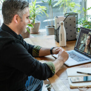 A man and a woman talking on a zoom call