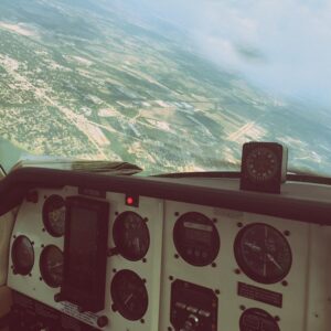 Plane cockpit looking out as the plane turns in the air
