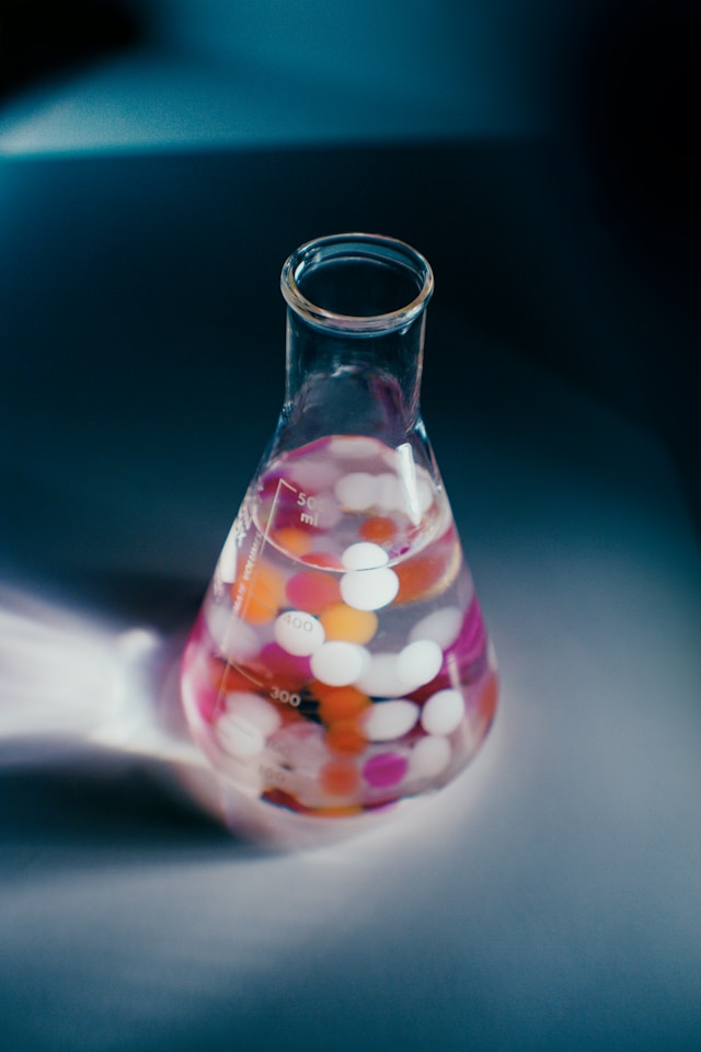 a glass beaker filled with colorful balls