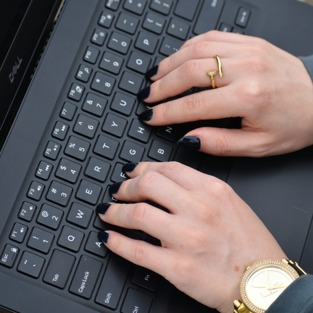a person typing on a laptop