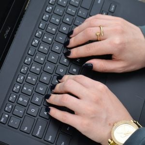a person typing on a laptop